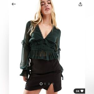 Dark green sheer ruffle blouse with button and tie detailing in center